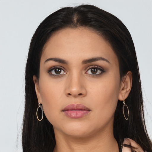 Neutral latino young-adult female with long  brown hair and brown eyes
