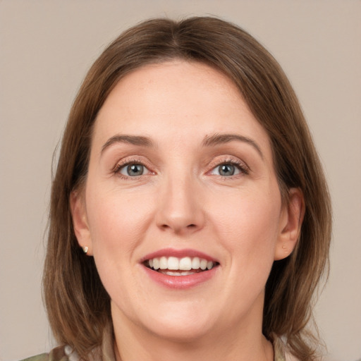 Joyful white young-adult female with medium  brown hair and grey eyes