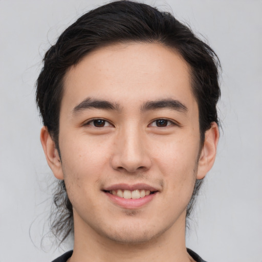 Joyful white young-adult male with medium  brown hair and brown eyes