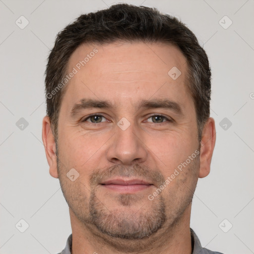 Joyful white adult male with short  brown hair and brown eyes