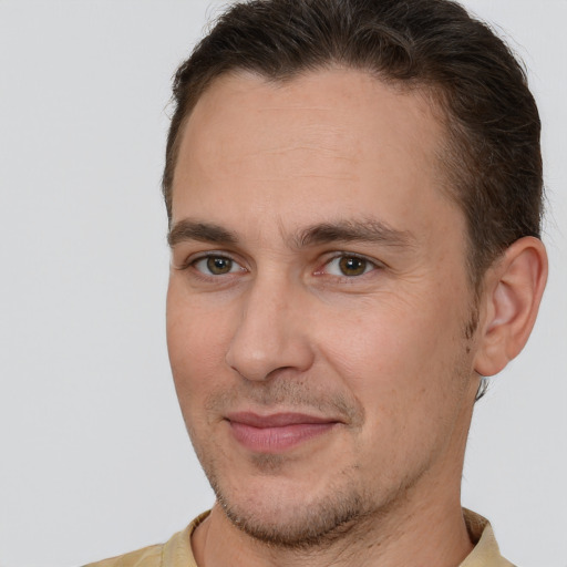 Joyful white adult male with short  brown hair and brown eyes