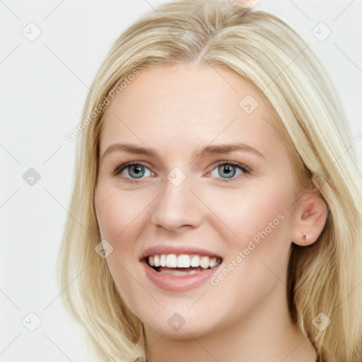 Joyful white young-adult female with long  brown hair and blue eyes