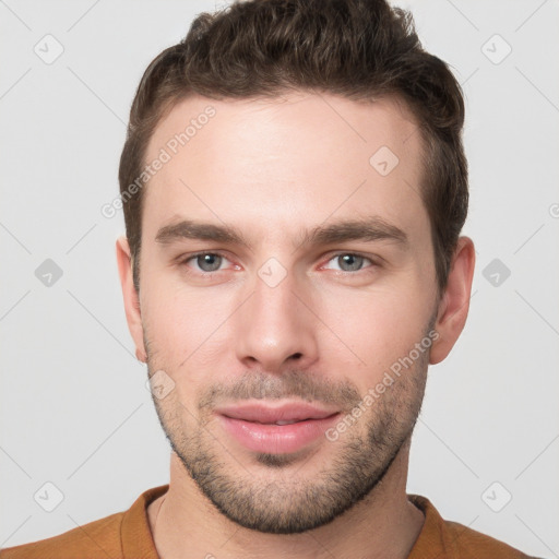 Joyful white young-adult male with short  brown hair and grey eyes