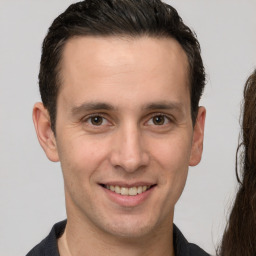 Joyful white adult male with short  brown hair and brown eyes