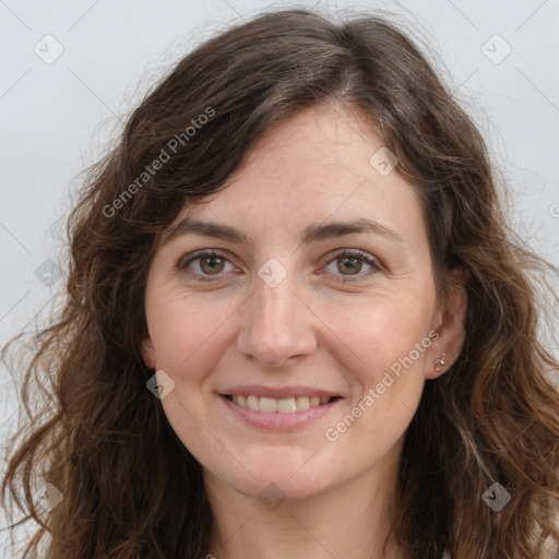 Joyful white adult female with long  brown hair and brown eyes