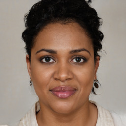 Joyful black adult female with short  brown hair and brown eyes