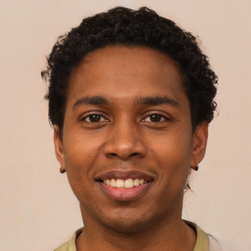 Joyful black young-adult male with short  black hair and brown eyes