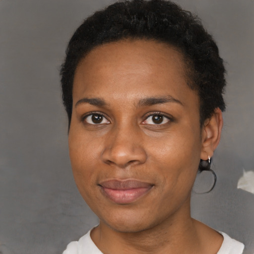 Joyful black adult female with short  brown hair and brown eyes