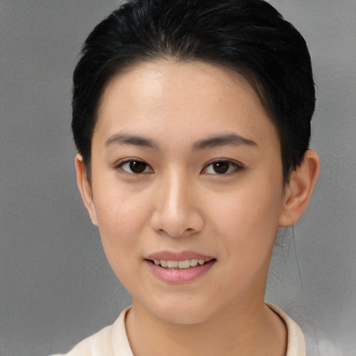 Joyful asian young-adult female with short  brown hair and brown eyes