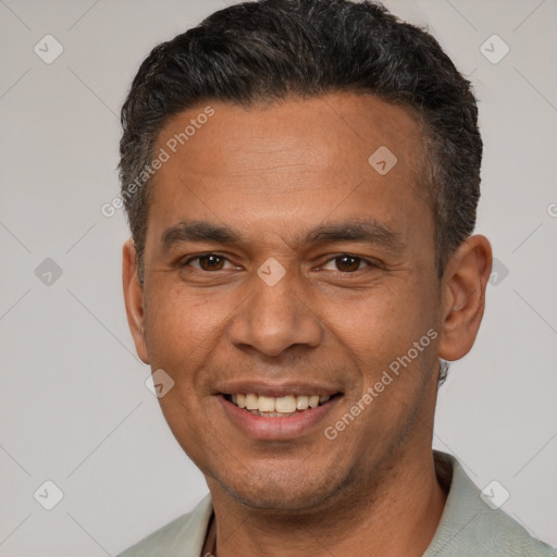 Joyful latino adult male with short  brown hair and brown eyes