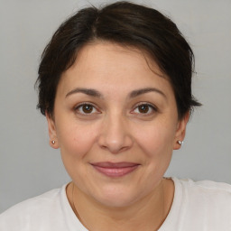 Joyful white adult female with short  brown hair and brown eyes