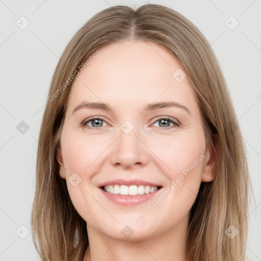 Joyful white young-adult female with long  brown hair and grey eyes