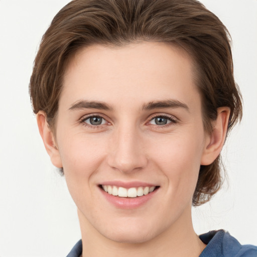 Joyful white young-adult female with short  brown hair and grey eyes