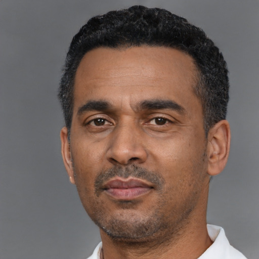 Neutral latino adult male with short  black hair and brown eyes