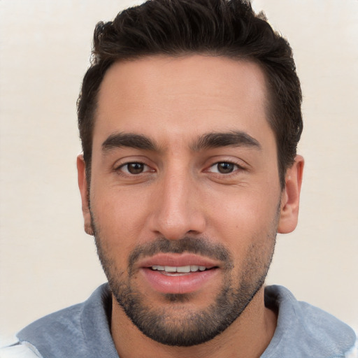 Joyful white young-adult male with short  black hair and brown eyes