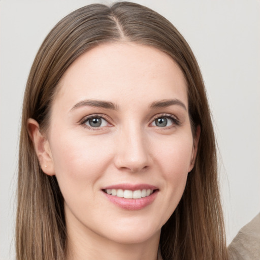 Joyful white young-adult female with long  brown hair and grey eyes