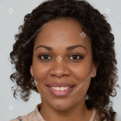 Joyful black adult female with medium  brown hair and brown eyes