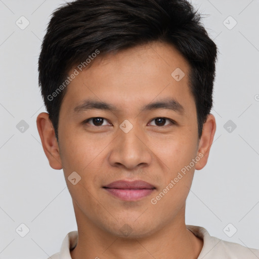 Joyful asian young-adult male with short  brown hair and brown eyes