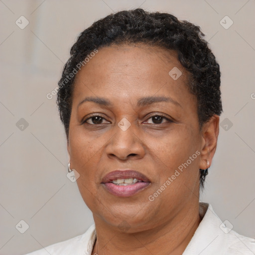 Joyful black adult female with short  brown hair and brown eyes