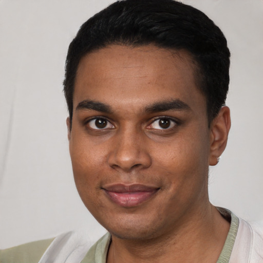 Joyful black young-adult male with short  black hair and brown eyes