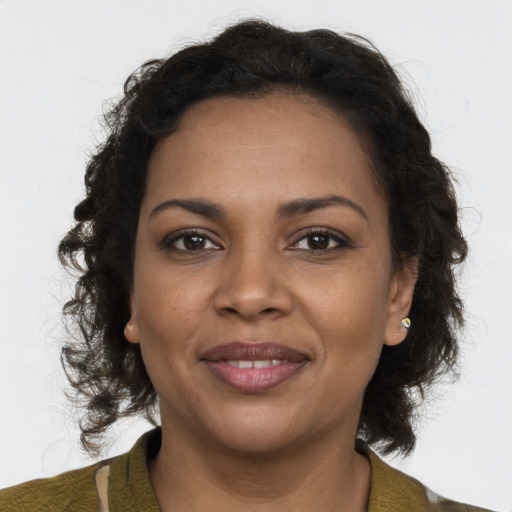 Joyful black young-adult female with medium  brown hair and brown eyes