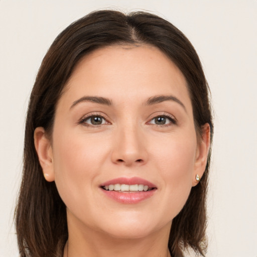 Joyful white young-adult female with long  brown hair and brown eyes