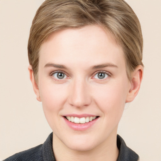 Joyful white young-adult female with short  brown hair and grey eyes