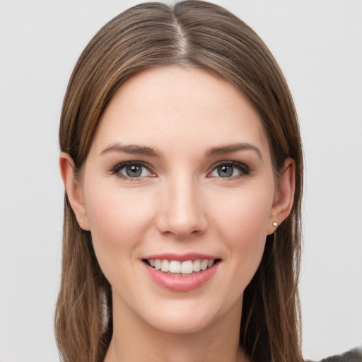 Joyful white young-adult female with long  brown hair and grey eyes