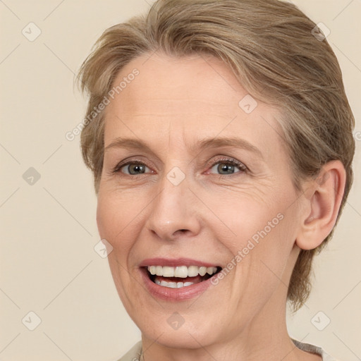 Joyful white adult female with medium  brown hair and green eyes