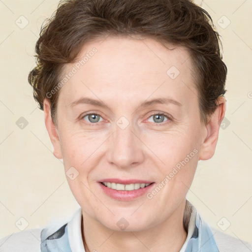 Joyful white adult female with short  brown hair and grey eyes