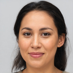 Joyful latino young-adult female with medium  brown hair and brown eyes