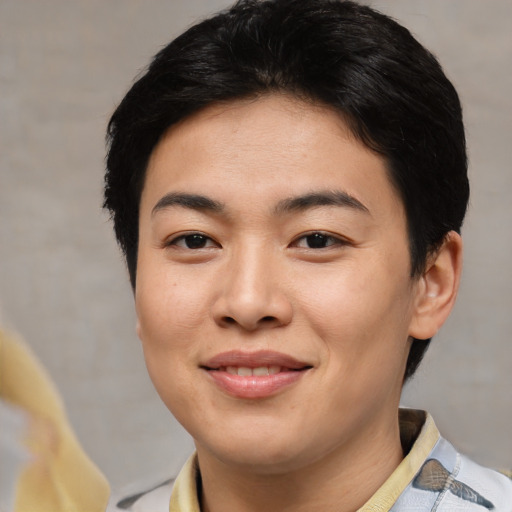 Joyful asian young-adult female with short  brown hair and brown eyes