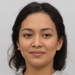 Joyful latino young-adult female with medium  brown hair and brown eyes