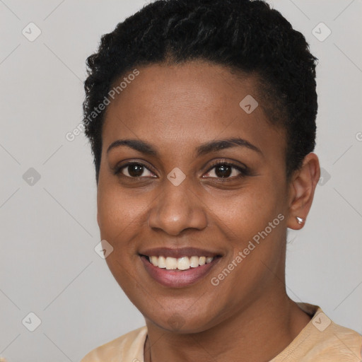 Joyful black young-adult female with short  black hair and brown eyes