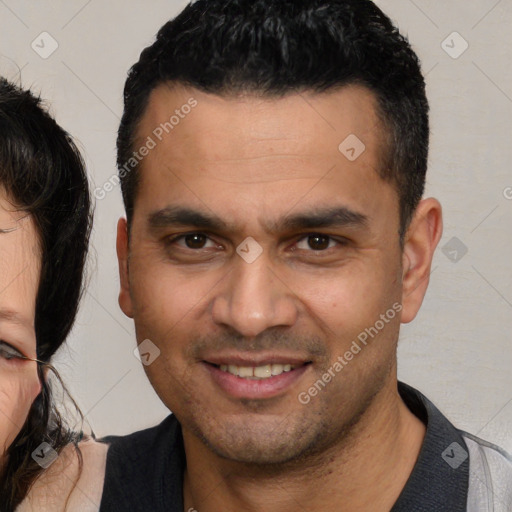 Joyful white young-adult male with short  black hair and brown eyes