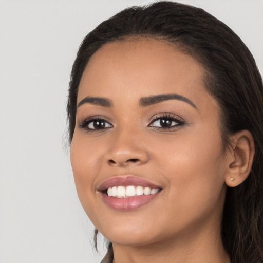 Joyful white young-adult female with long  black hair and brown eyes