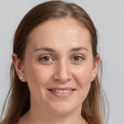 Joyful white young-adult female with long  brown hair and grey eyes