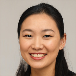 Joyful asian young-adult female with long  brown hair and brown eyes