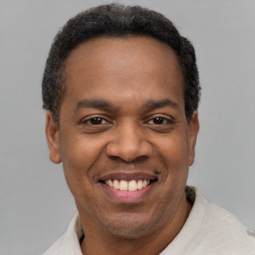 Joyful latino adult male with short  black hair and brown eyes