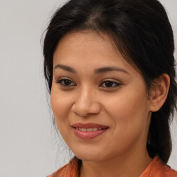 Joyful asian young-adult female with long  brown hair and brown eyes