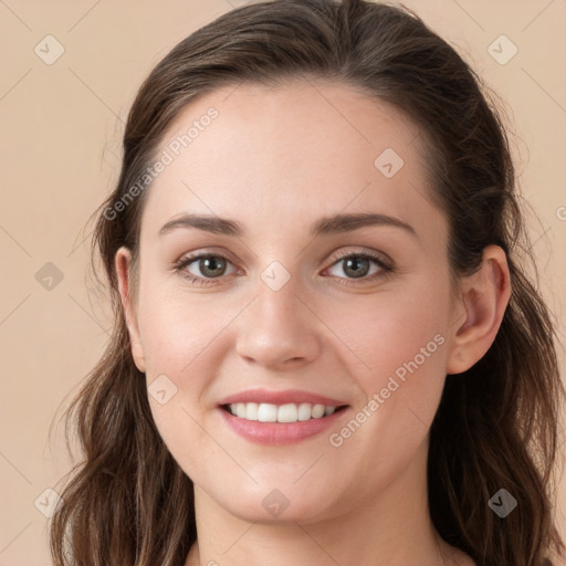 Joyful white young-adult female with long  brown hair and grey eyes