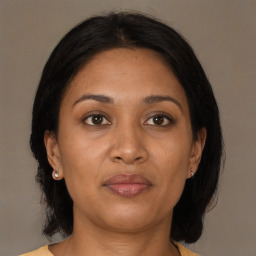 Joyful black adult female with medium  brown hair and brown eyes