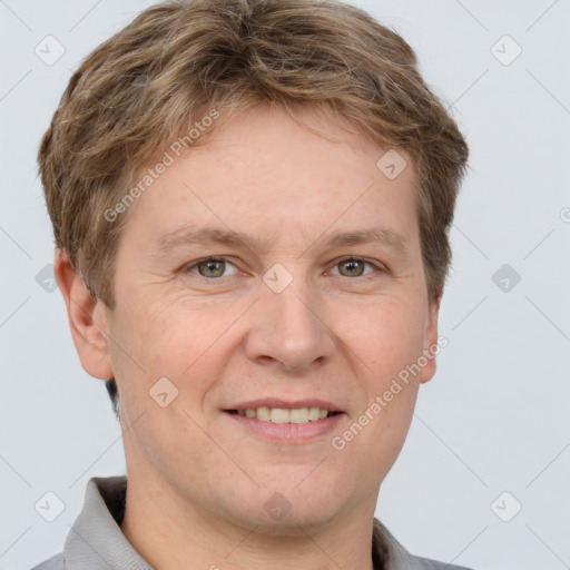 Joyful white adult male with short  brown hair and grey eyes