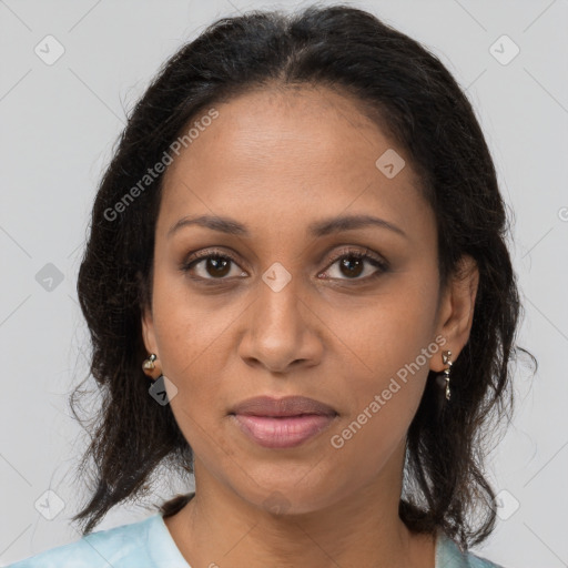 Joyful black adult female with medium  brown hair and brown eyes