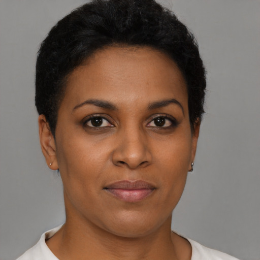 Joyful black young-adult female with short  brown hair and brown eyes