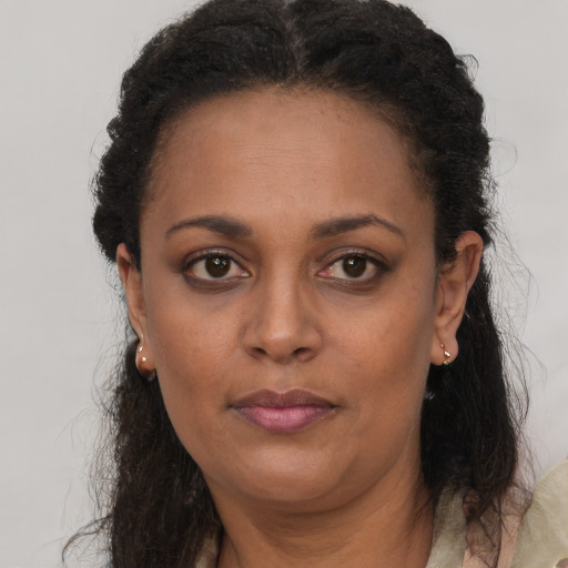 Neutral black adult female with long  brown hair and brown eyes