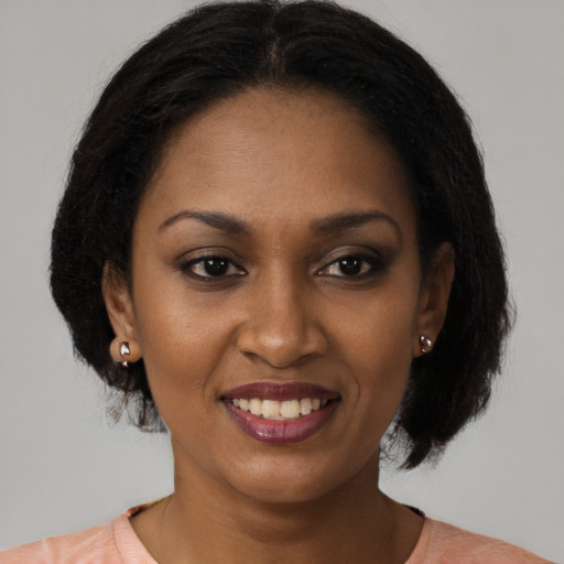 Joyful black young-adult female with medium  brown hair and brown eyes