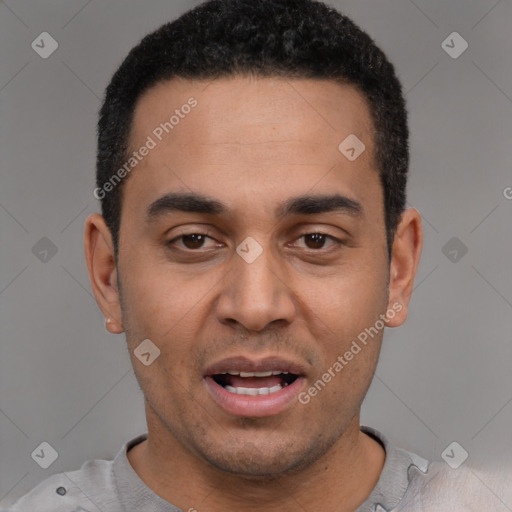 Joyful white young-adult male with short  black hair and brown eyes