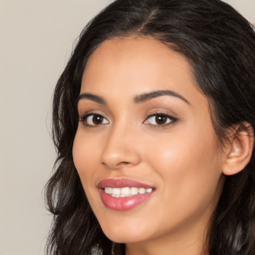 Joyful latino young-adult female with long  brown hair and brown eyes