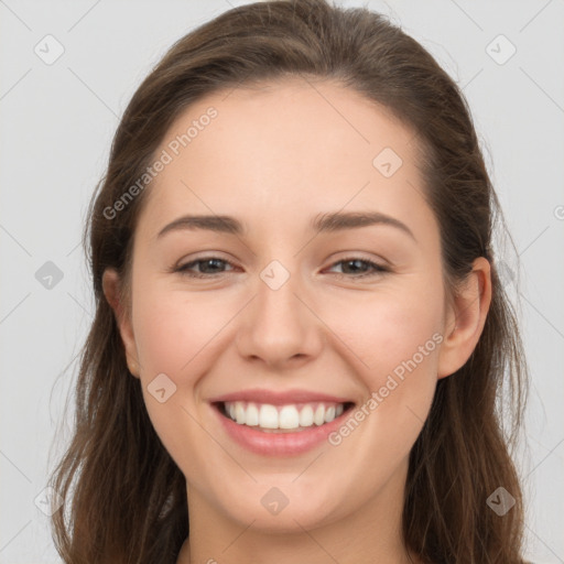 Joyful white young-adult female with long  brown hair and grey eyes